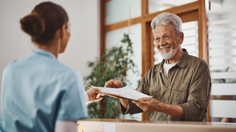 patient filling out paperwork at front desk