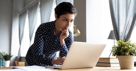 concerned woman looking at computer