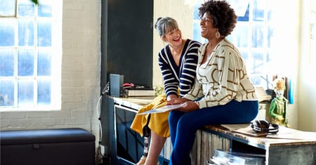 two business women laughing