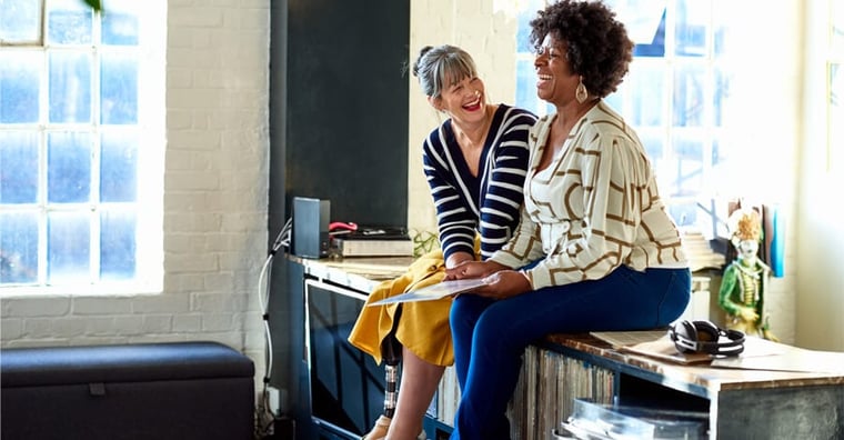 two business women laughing