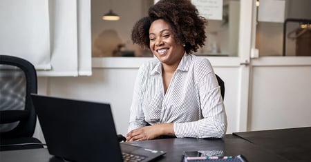 professional woman smiling at computer