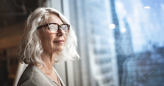 healthcare executive looking out a city window