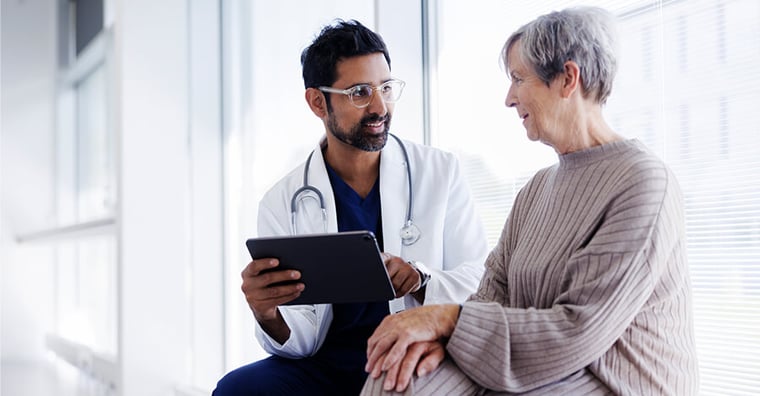 doctor speaking with elderly patient