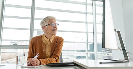 business woman taking notes on computer