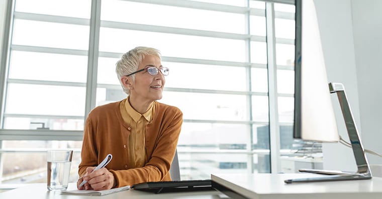 business woman taking notes on computer