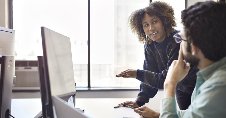 two people working together in office