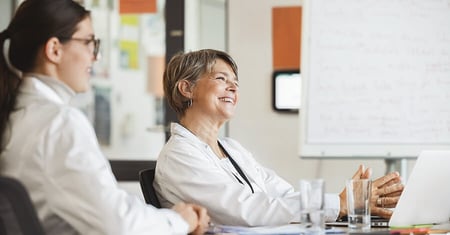 healthcare colleagues sitting at table having pleasant conversation