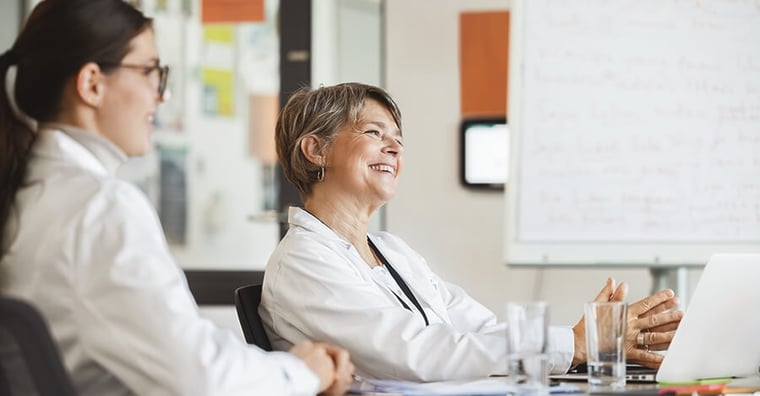 healthcare colleagues sitting at table having pleasant conversation