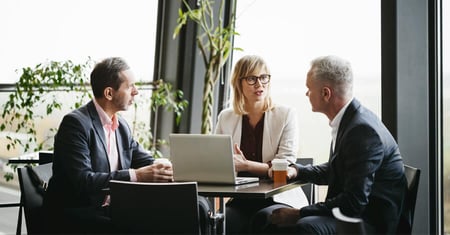 executives sitting around a table talking