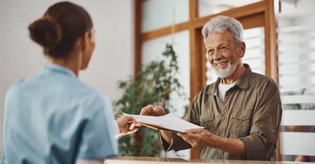 patient filling out paperwork at front desk