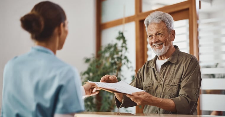 patient filling out paperwork at front desk