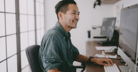 happy worker at desk