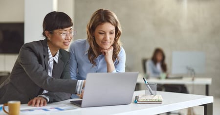 two business women looking at the computer