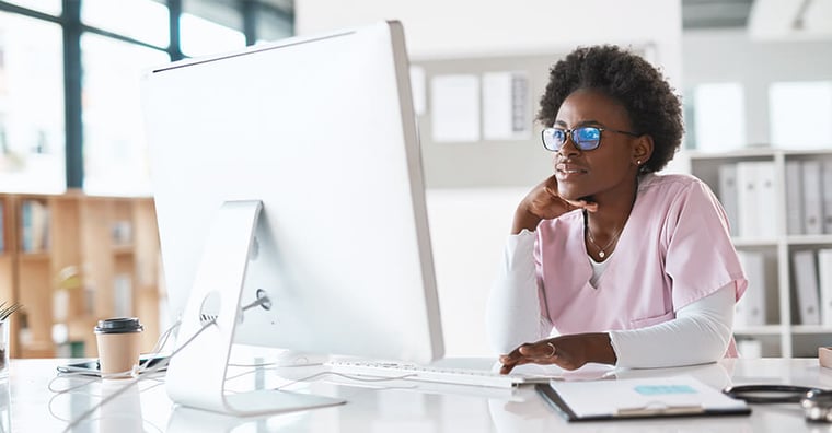 Healthcare professional looking at computer