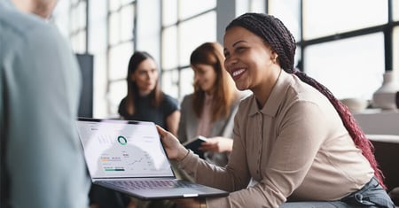 business woman showing male colleague KPIs