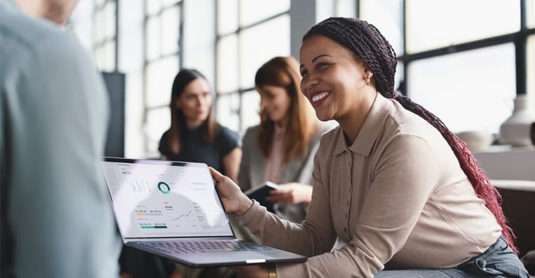 business woman showing male colleague KPIs