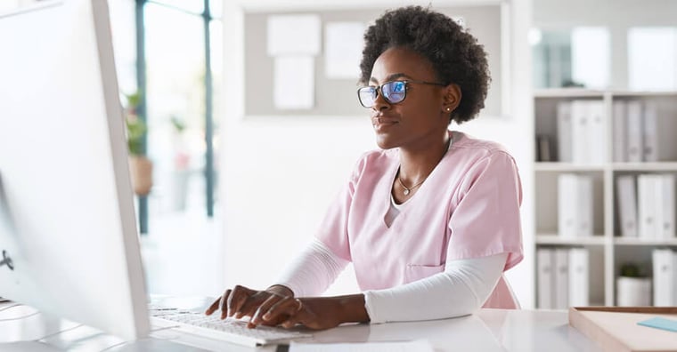 Healthcare professional looking at computer
