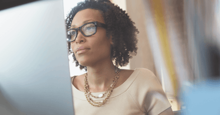 serious woman looking at computer