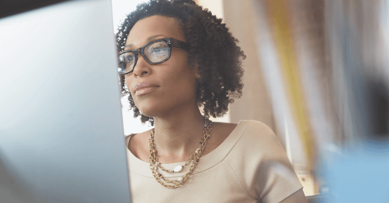 serious woman looking at computer
