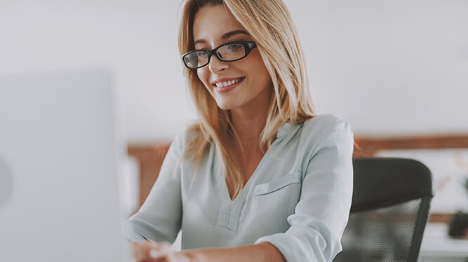 smiling woman at a computer