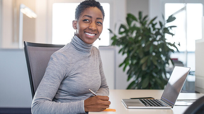 smiling woman using a laptop