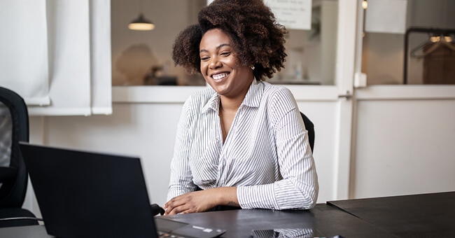 smiling woman using a laptop